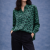 Camisa verde de mujer con estampado animal print, manga larga y corte recto, combinada con pantalón negro.